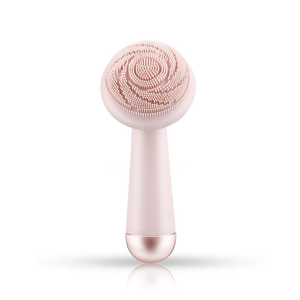 Pink silicone facial cleansing brush full product view showing soft silicone bristle head and roller massage tip, white background