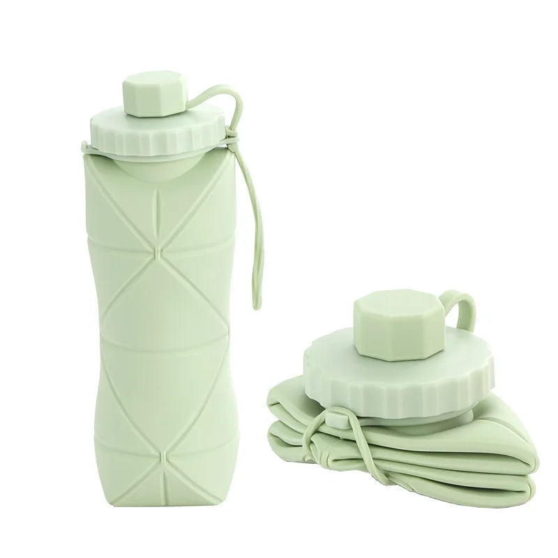Foldable silicone water bottle in Green Matcha shown upright and folded flat, with carrying strap – 600ml portable reusable bottle