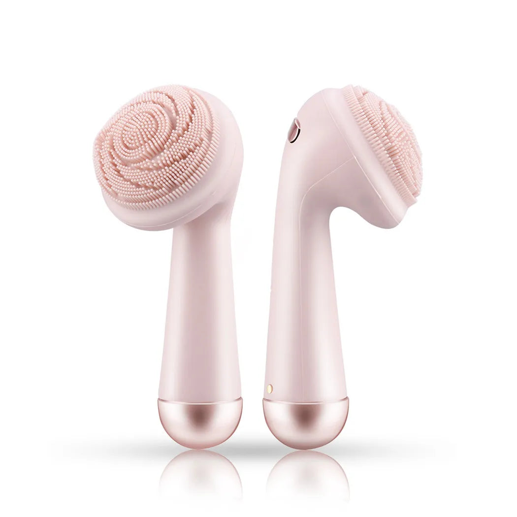 Pink silicone facial cleansing brush front and back view showing bristle head side and roller massage side, white background
