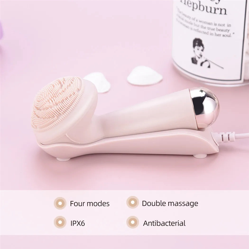 Pink silicone facial cleansing brush with charging dock showing four modes, double massage, IPX6 and antibacterial features